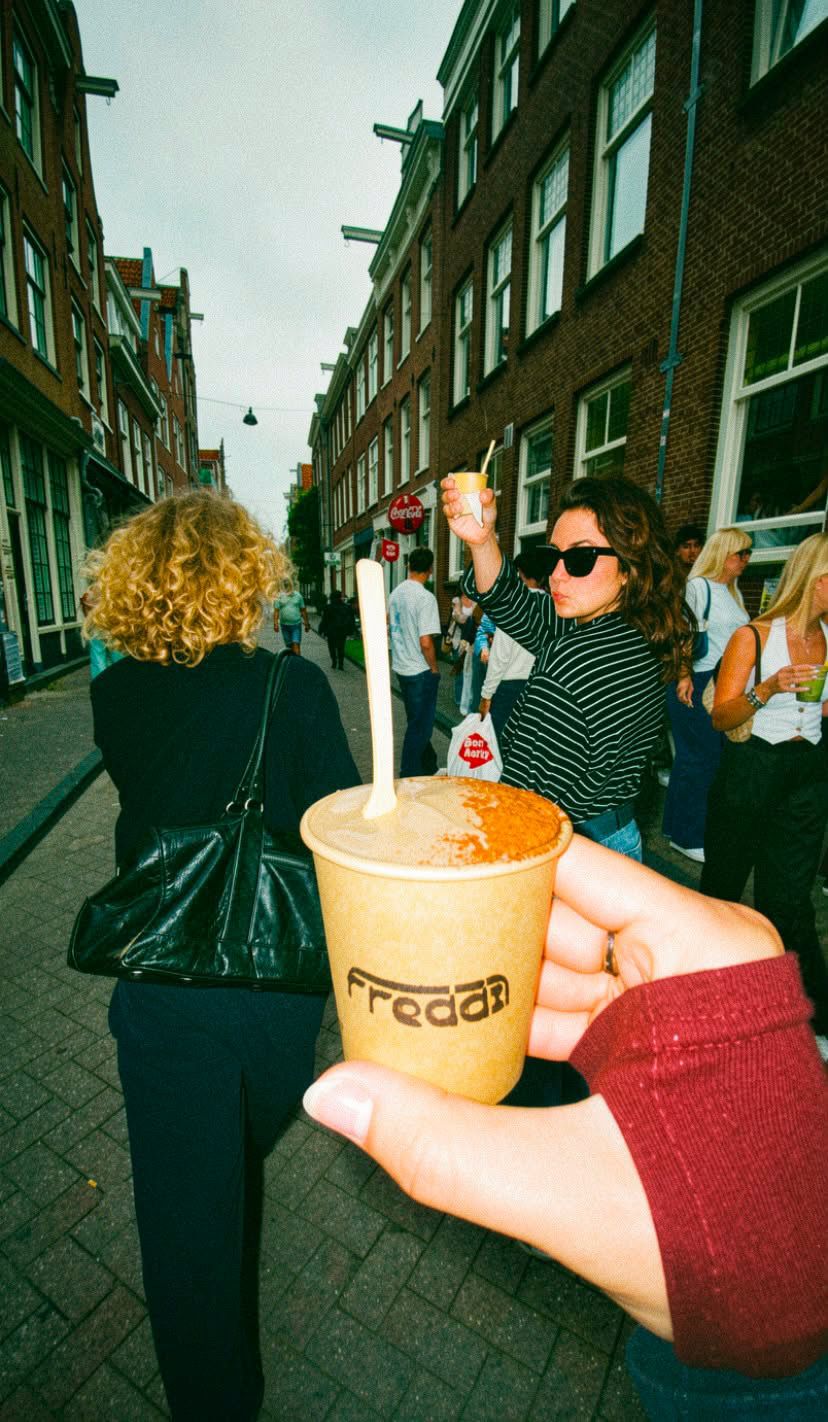 A Freddi cup held up in an Amsterdam street