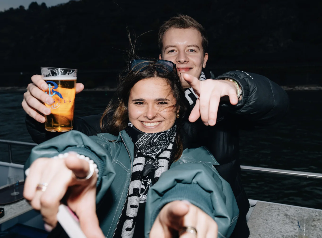 Einmal Ebsler, immer Ebsler: two Hunters on the Rhine boat, beer up, pointing at the lens