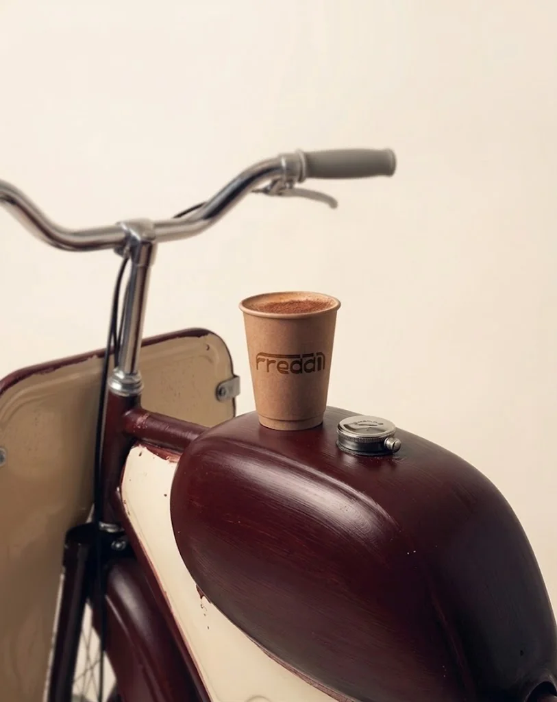 A Freddi cup resting on the tank of a vintage moped