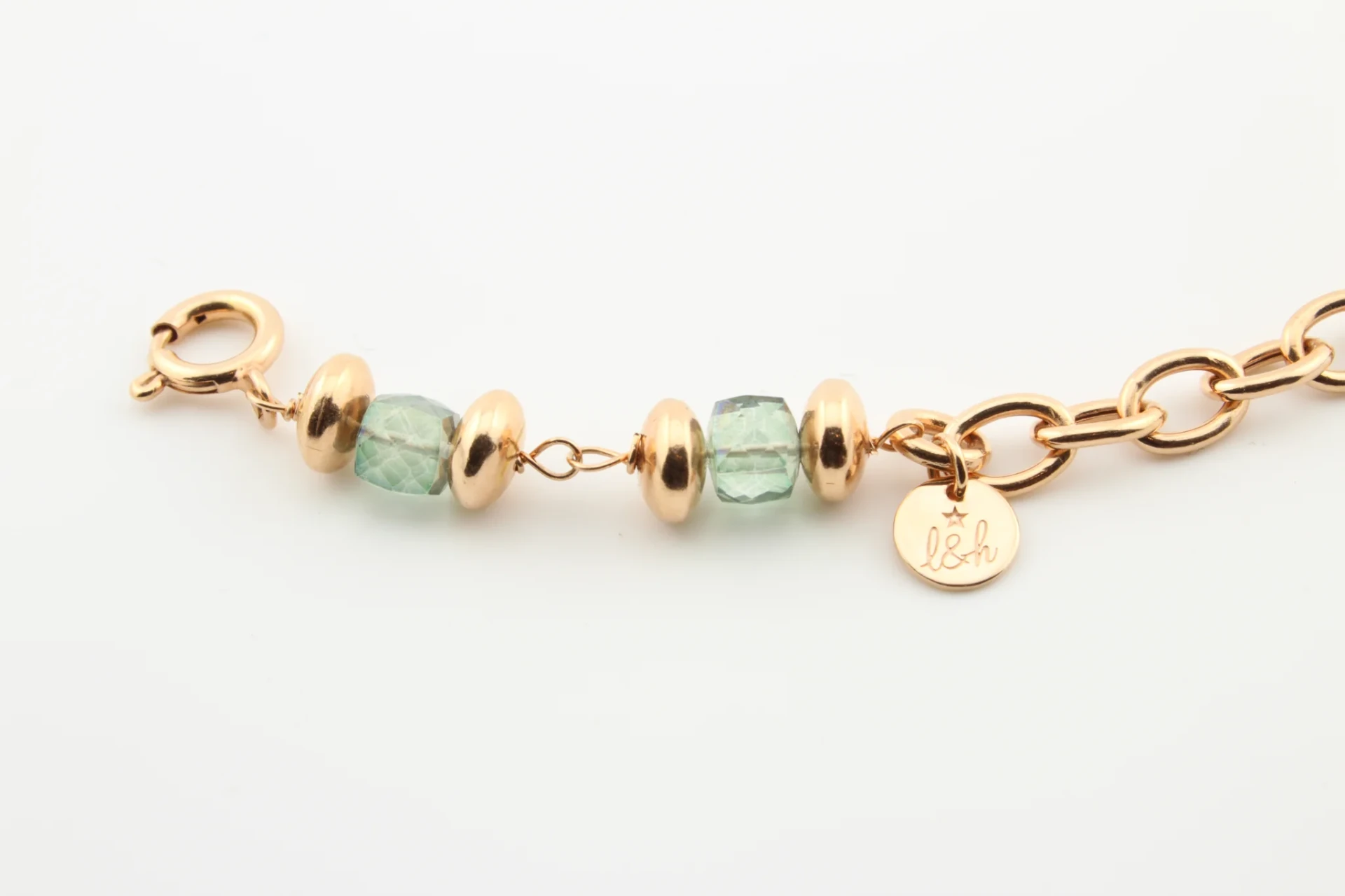 The l&h engraved tag and clasp on a gold chain bracelet